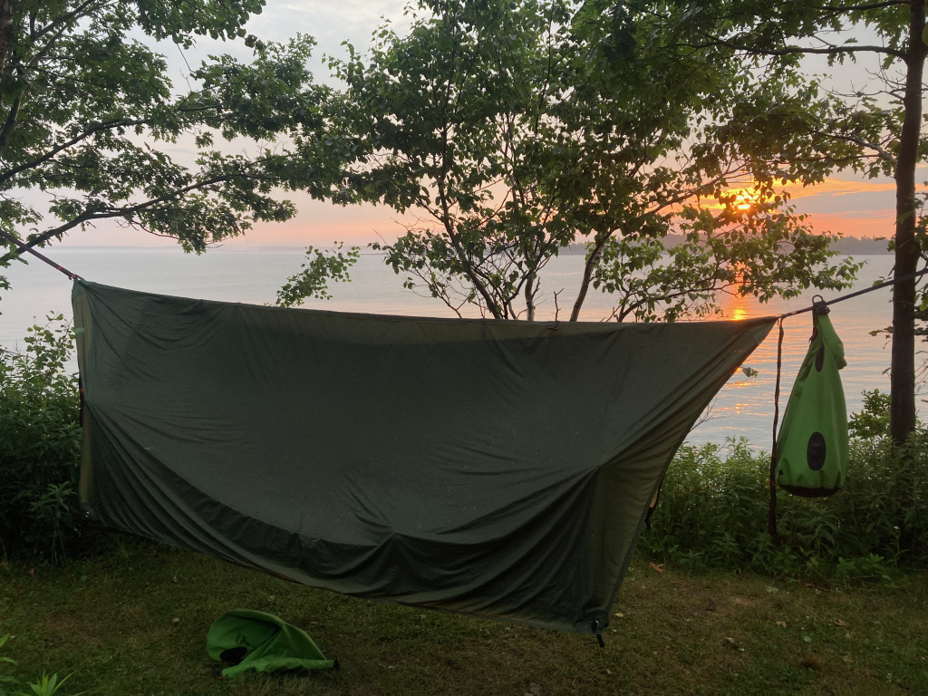 The Haven XL with the sea and sun setting behind it.